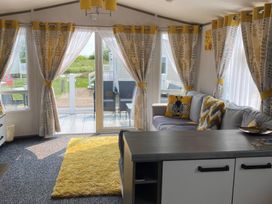 A living room with curtains and a sofa at Primrose Valley Holiday Park - Holiday Accommodation 9833 in Filey