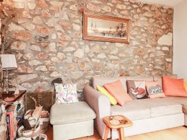 A living room with a stone wall and a sofa at Harford