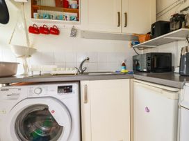 A kitchen with a sink, washing machine, microwave, and fridge at Harford
