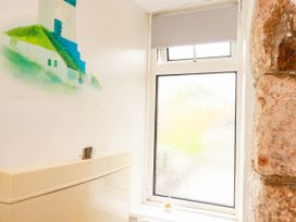 A bathroom featuring a toilet and a decorative wall at Harford