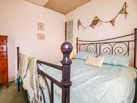 A bedroom with a bed and drawers at Harford
