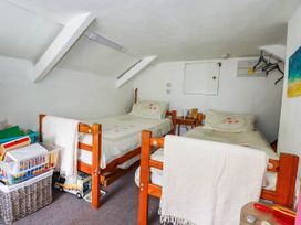 A bedroom with two beds and storage bins at Harford