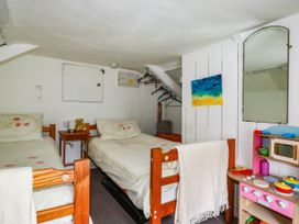 A bedroom with two beds and a toy kitchen set at Harford