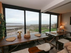 A dining room with a view of the beach at The Boat House - Port Eynon