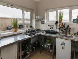 A kitchen with sink and utensils at The Boat House - Port Eynon