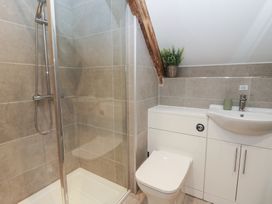 A bathroom with shower, toilet, and sink at The Boat House - Port Eynon