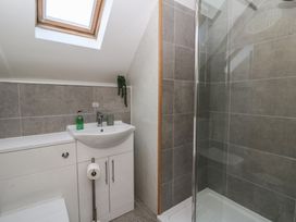 A bathroom with a sink and shower at The Boat House - Port Eynon