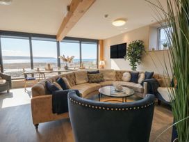 A living room with a sofa and coffee table at The Boat House - Port Eynon