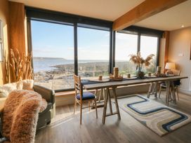A dining area with a table and chairs at The Boat House - Port Eynon