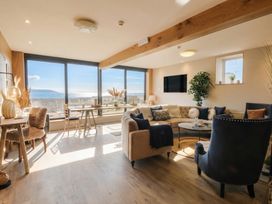 A living room with a sofa and a coffee table at The Boat House - Port Eynon