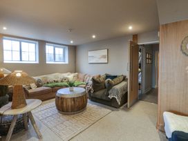 A living room with a sofa and coffee table at The Boat House - Port Eynon