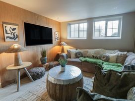 A living room with a sofa and television at The Boat House - Port Eynon