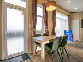 A dining room with a table and chairs at Blue Skies in Caernarfon