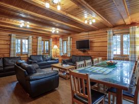 A living room with sofas and a dining table at Kinder Lodge (Pet) Fowlis near Dundee