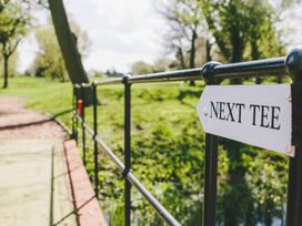 A sign indicating 'Next Tee' on a path at Garden Pod, Waltham