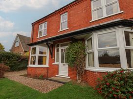 A house with windows and a doorway surrounded by plants at The Manse in Whitby