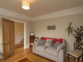 A living room with a sofa and framed pictures at The Manse in Whitby