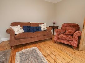 A living room with a sofa and armchair at The Manse in Whitby
