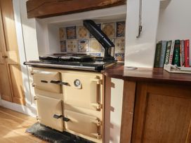 A kitchen with a cream stove and books on a wooden countertop at The Manse in Whitby