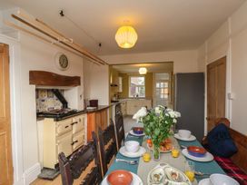 A kitchen with a dining table set for breakfast at The Manse in Whitby