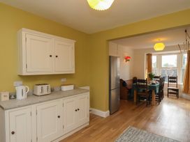 A kitchen with cabinets and a dining area at The Manse in Whitby