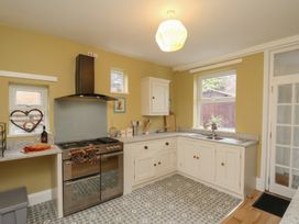 A kitchen with stove, sink, cabinets, and countertop at The Manse in Whitby