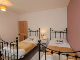 A bedroom with two single beds and a nightstand at The Manse in Whitby