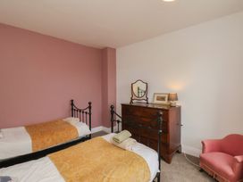 A bedroom with two beds and a dresser at The Manse in Whitby
