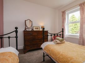 A bedroom with two beds and a wooden dresser at The Manse in Whitby