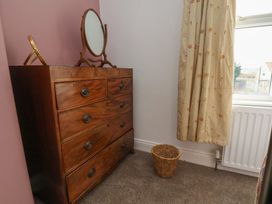 A bedroom with a dresser and mirror at The Manse in Whitby