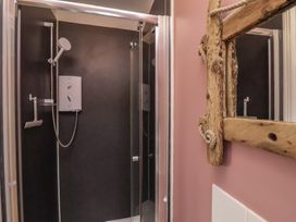 A shower area with a mirror at The Manse in Whitby