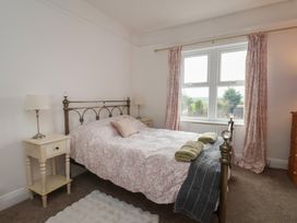 A bedroom with a bed and bedside table at The Manse in Whitby