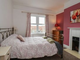 A bedroom with a bed and a dressing table at The Manse in Whitby