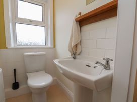 A bathroom with a toilet and sink at The Manse in Whitby