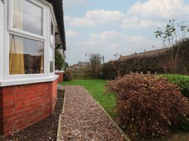 A garden with a path and bushes at The Manse in Whitby
