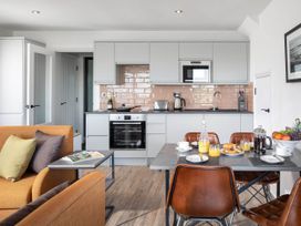 A kitchen with modern furniture and breakfast items at Ferry Hills in Laugharne