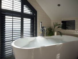 A bathroom with a bathtub near a window at Ferry Hills in Laugharne