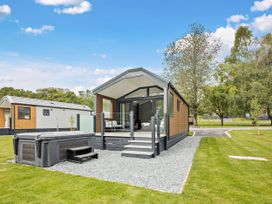 An outdoor space with a house and hot tub at Prion Spa in Llandyrnog
