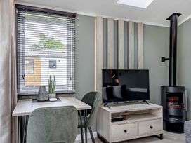 A living room with a table and chairs at Prion Spa in Llandyrnog
