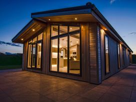 An exterior view of a modern house with large windows at Darwin Retreat in Wigton