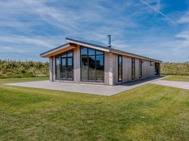 A house with large windows and a patio at Darwin Retreat in Wigton