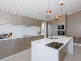 A kitchen with cabinets and appliances at Darwin Retreat in Wigton