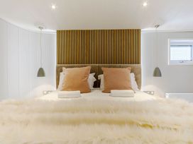 A bedroom with a bed and lamps at The Sheraton Retreat in Wigton