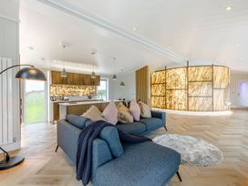 A living room featuring a sofa and kitchen island at The Sheraton Retreat in Wigton