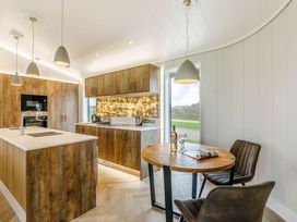 A kitchen with an island and dining area at The Sheraton Retreat in Wigton