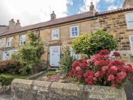 A house with flower beds and greenery at 21 High Street in Scarborough