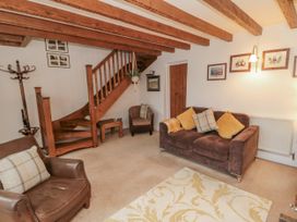 A living room with seating and staircase at 21 High Street in Scarborough
