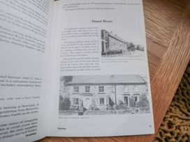 A page from a book with text and a photograph of Manor House at 21 High Street, Scarborough
