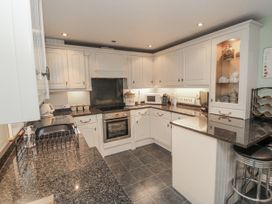 A kitchen with cabinets and appliances at 21 High Street in Scarborough