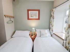 A bedroom with two beds and a window at 21 High Street, Scarborough